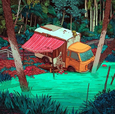 Aztec sitting in a makeshift motorhome on the banks of a river.