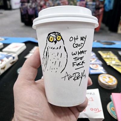 a coffee cup with a doodle of an owl and the words "oh my god, what the fuck" on it