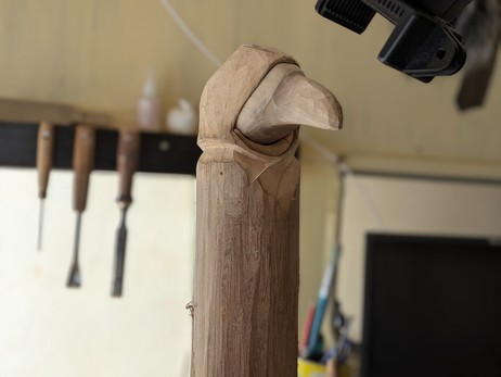 Ongoing process of woordcarving an humanoid crow. This a draft. A rough face and the beginning of a hooded cloak.